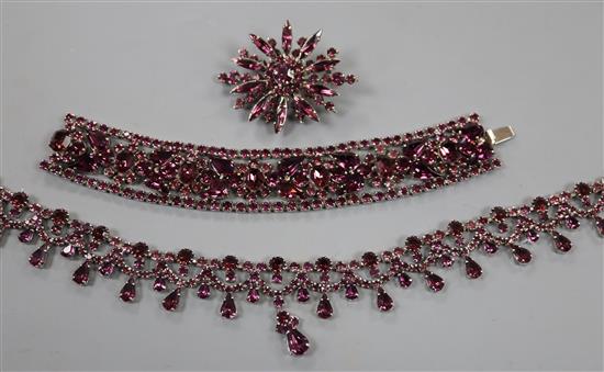 A suite of purple paste jewellery, comprising bracelet, necklace and brooch